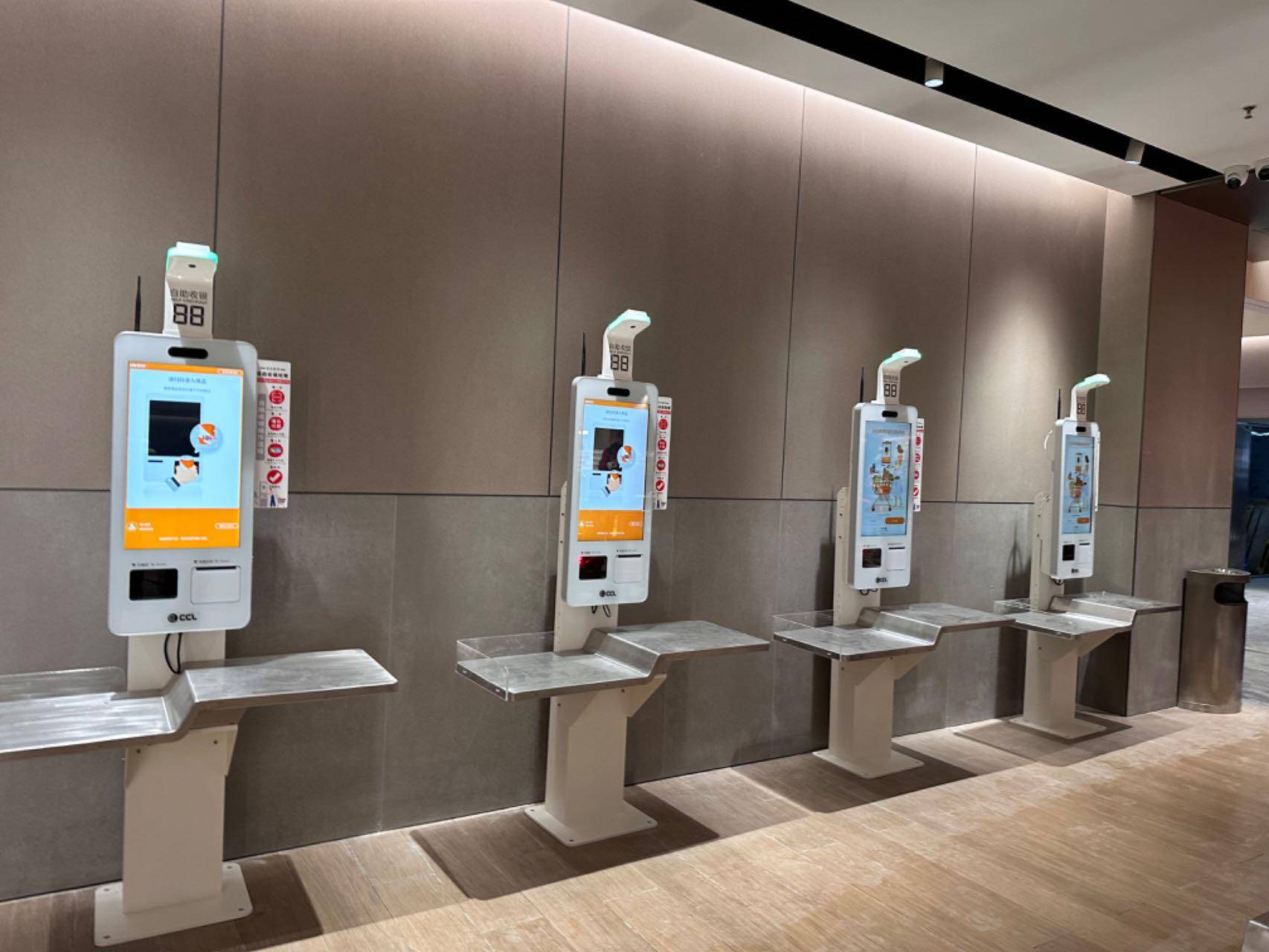 Ai-powered checkout kiosks with loss prevention features, featuring self-service screens and automated scanning for efficient and secure transactions.