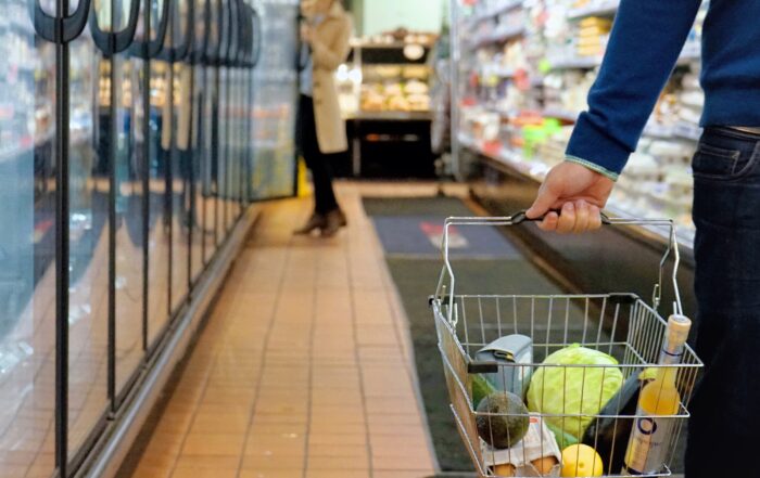 Shopper carrying groceries to an ai self-service cashiering checkout for loss prevention.