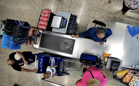 Supermarket checkout scene,cashier and customers at a register, ideal for demonstrating retail ai loss prevention sdk use cases in retail loss prevention and transaction monitoring