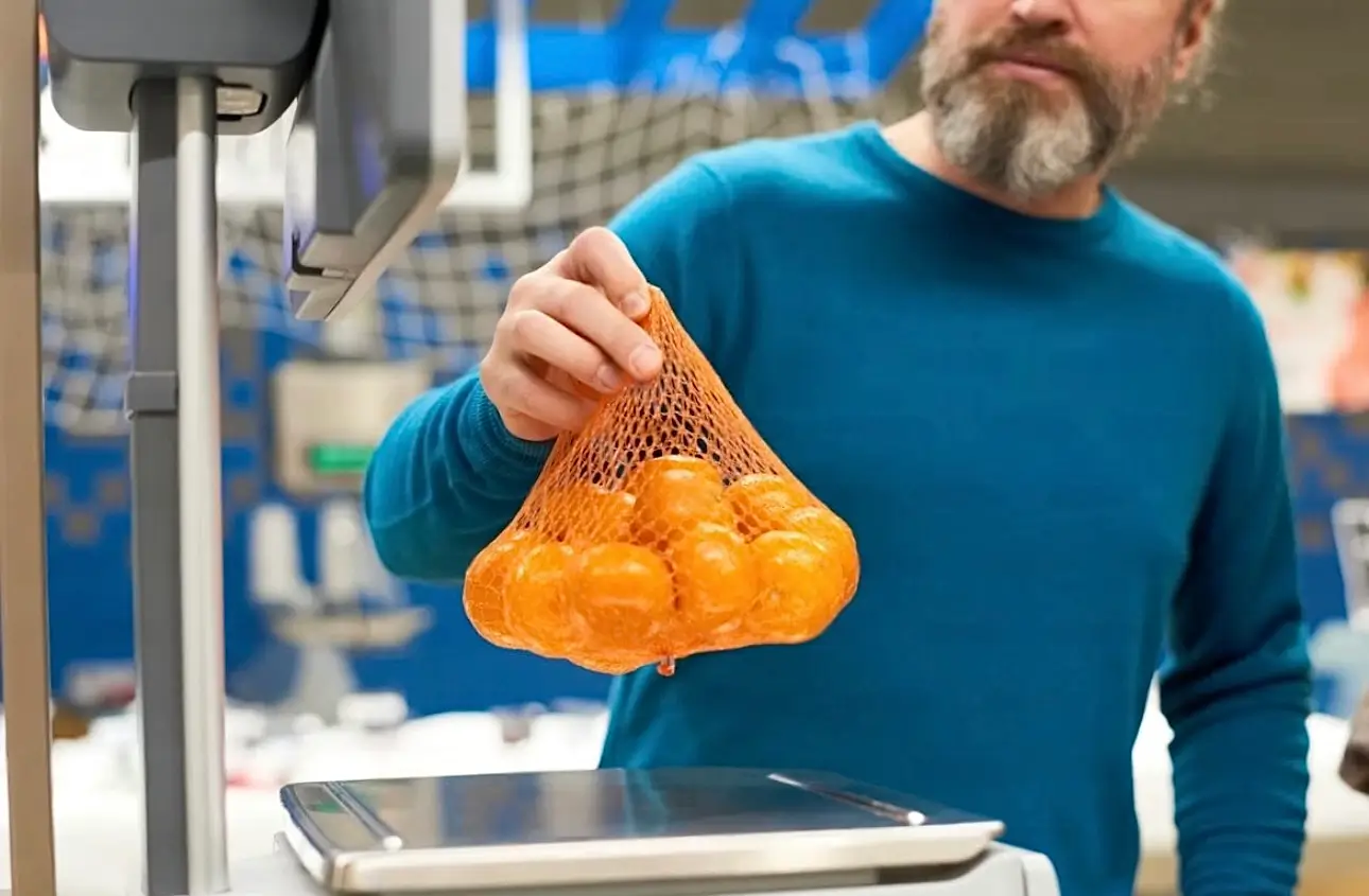 Self-service scale in supermarket weighing fresh produce