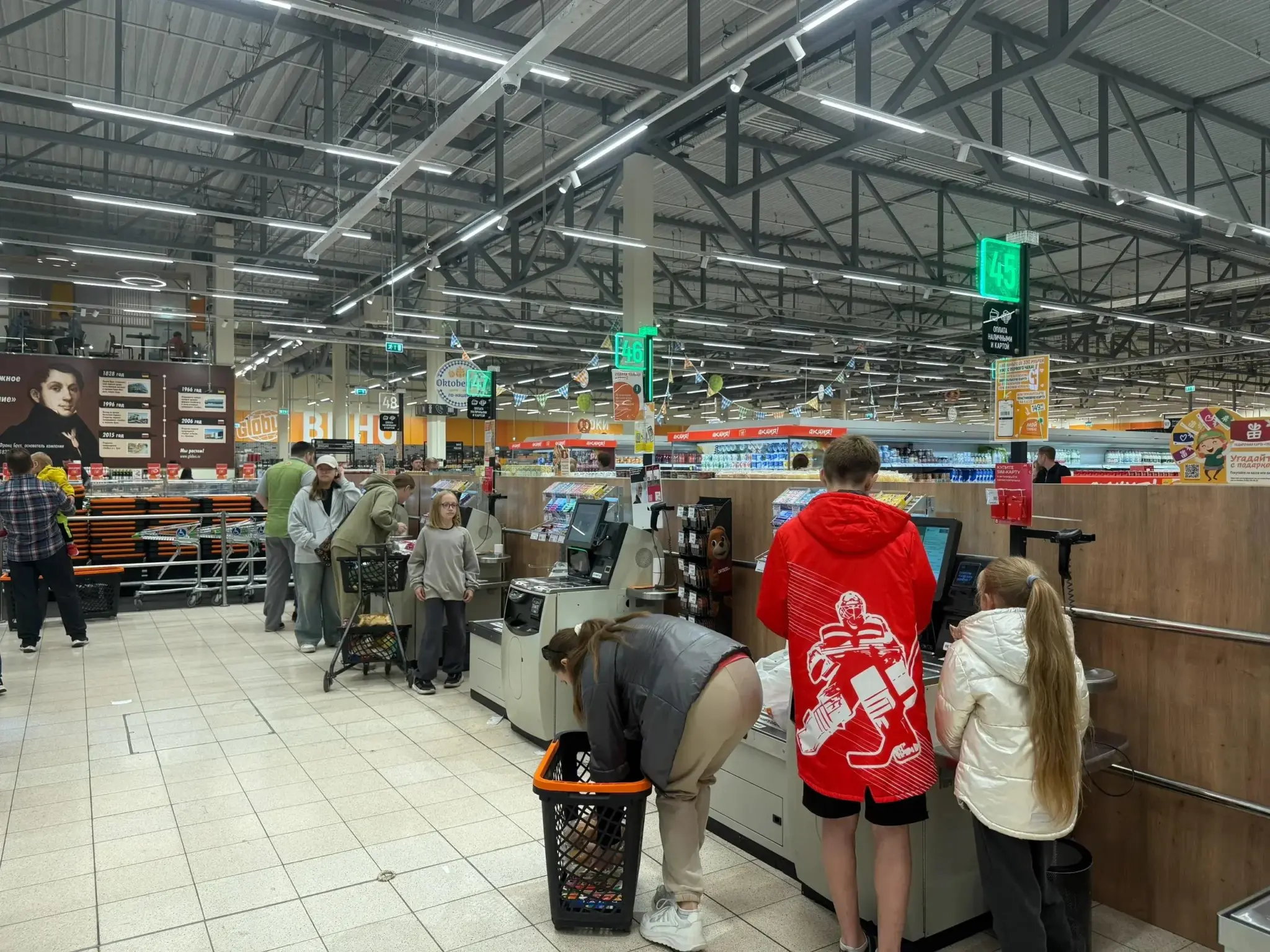 Supermarket Self-Checkout Scene, With Customers Using The Machines, Illustrating Self-Checkout Loss Prevention In A Retail Environment. Supermarket self-checkout scene, with customers using the machines, illustrating self-checkout loss prevention in a retail environment.
