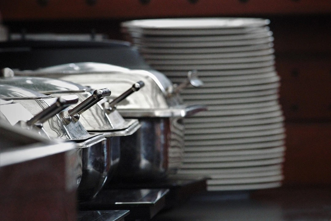 10 Buffet Chafing Dishes And Stacked Plates At A Serving Station Buffet chafing dishes and stacked plates at a serving station
